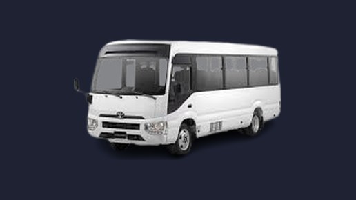 A white Toyota Coaster minibus, front three-quarter view
